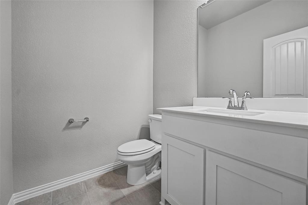 1205 Colca Drive Springtown, TX 76082 - Photo 8 of 37 White vanity with integrated sink, chrome faucet, and rectangular mirror