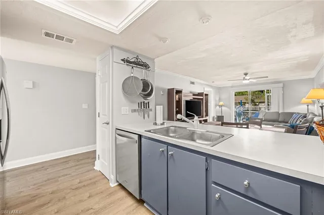 a kitchen with a sink and a refrigerator