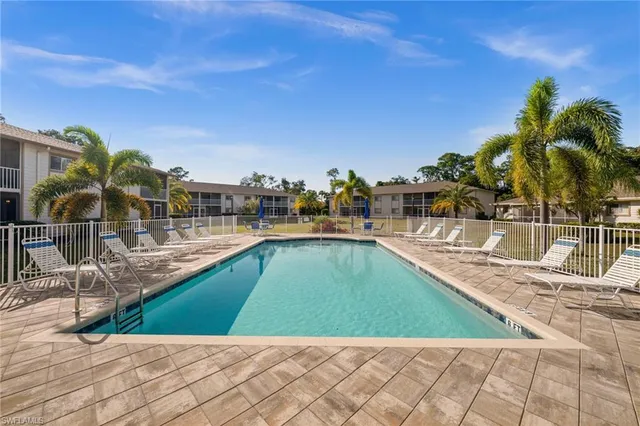 a view of a swimming pool with an outdoor seating