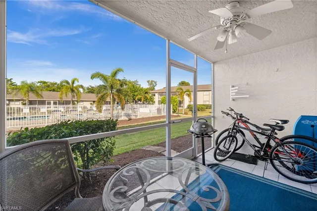 a view of a patio with table and chairs