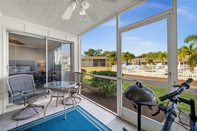 a work room with furniture and a floor to ceiling window