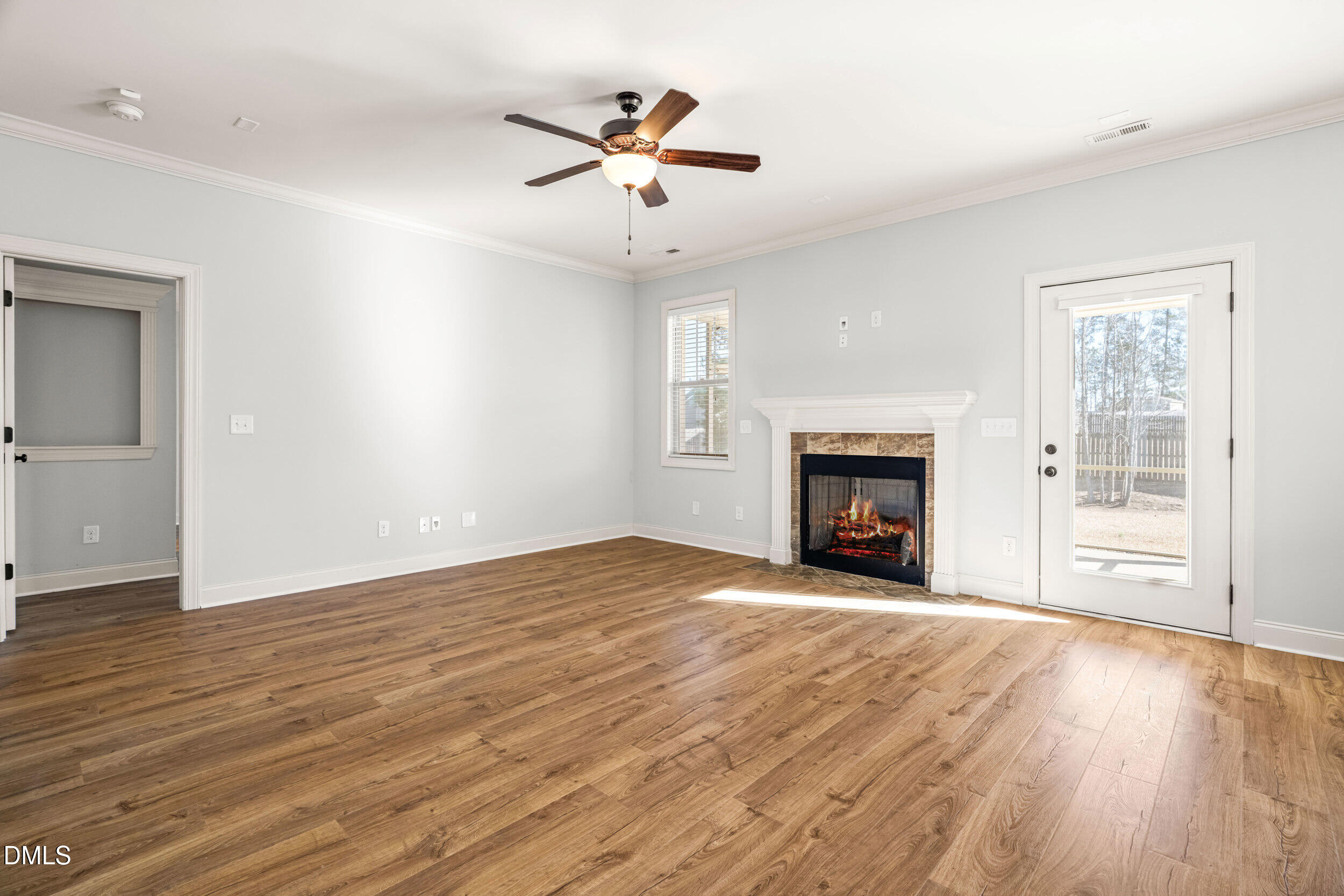 86 Sharpstone Lane Clayton, NC 27527 - Photo 12 of 36 a view of an empty room with wooden floor fireplace and a window