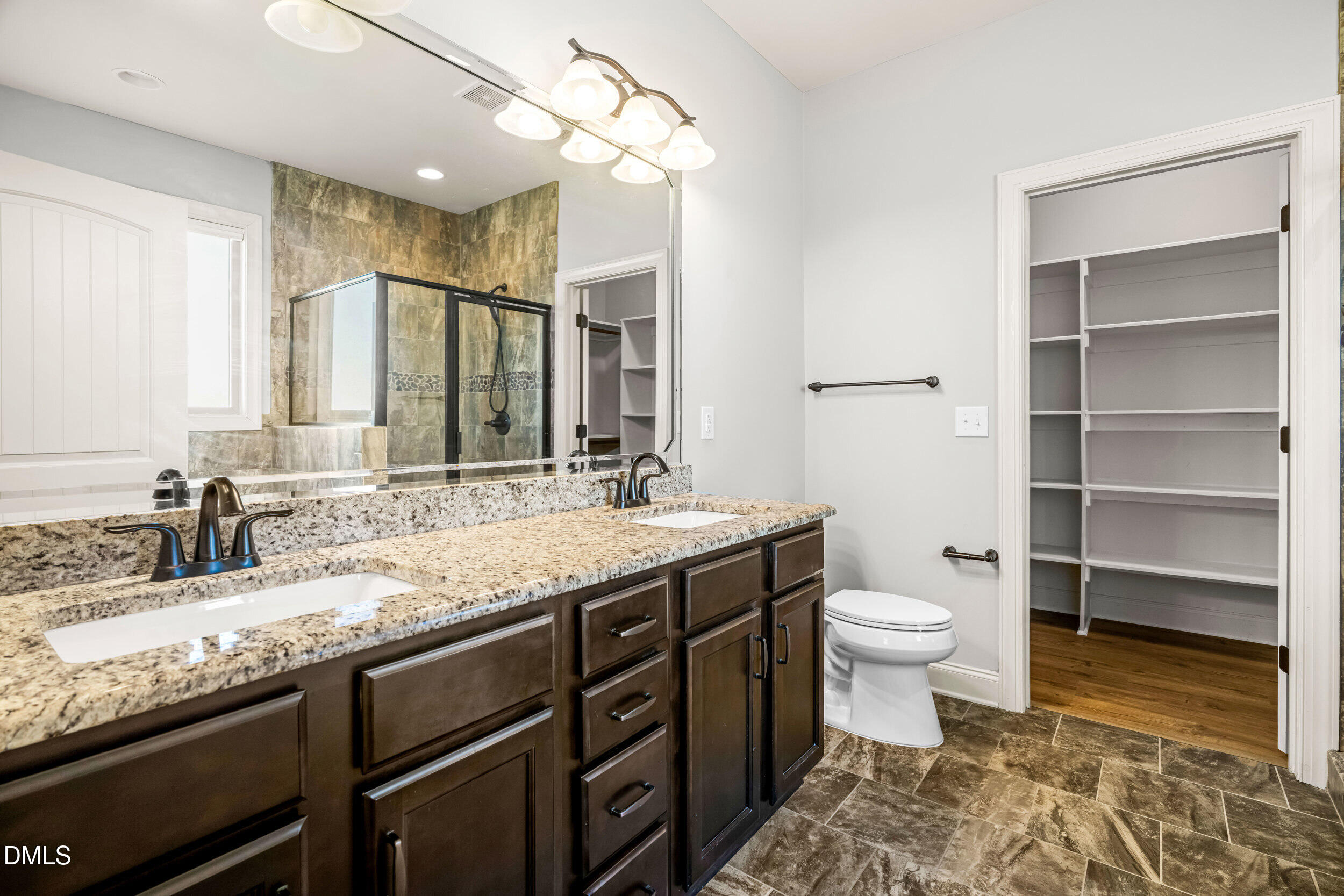 86 Sharpstone Lane Clayton, NC 27527 - Photo 20 of 36 a bathroom with a granite countertop sink a toilet and a mirror