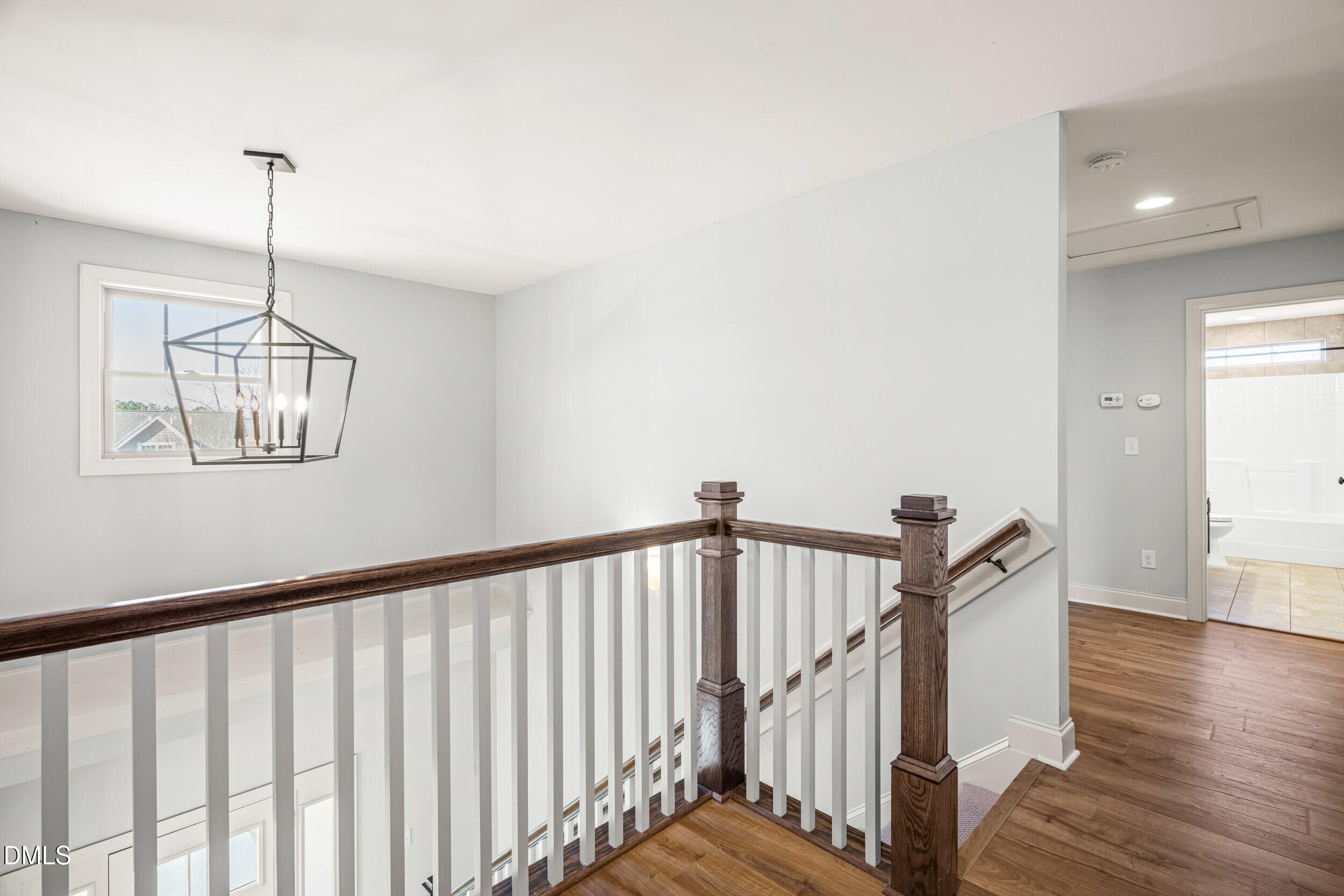 86 Sharpstone Lane Clayton, NC 27527 - Photo 23 of 36 a view of staircase with railing and a chandelier