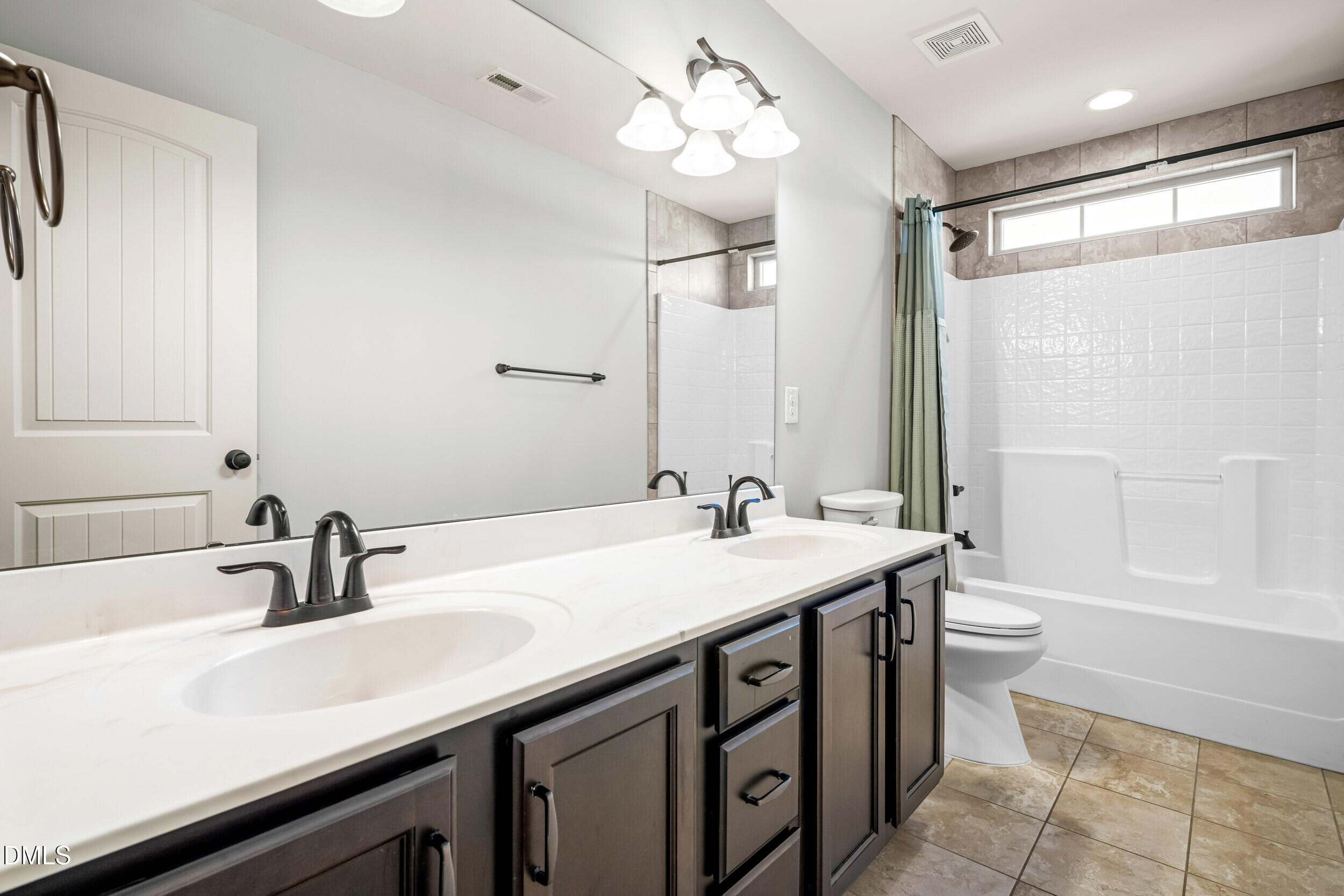 86 Sharpstone Lane Clayton, NC 27527 - Photo 26 of 36 a bathroom with a double vanity sink and a mirror