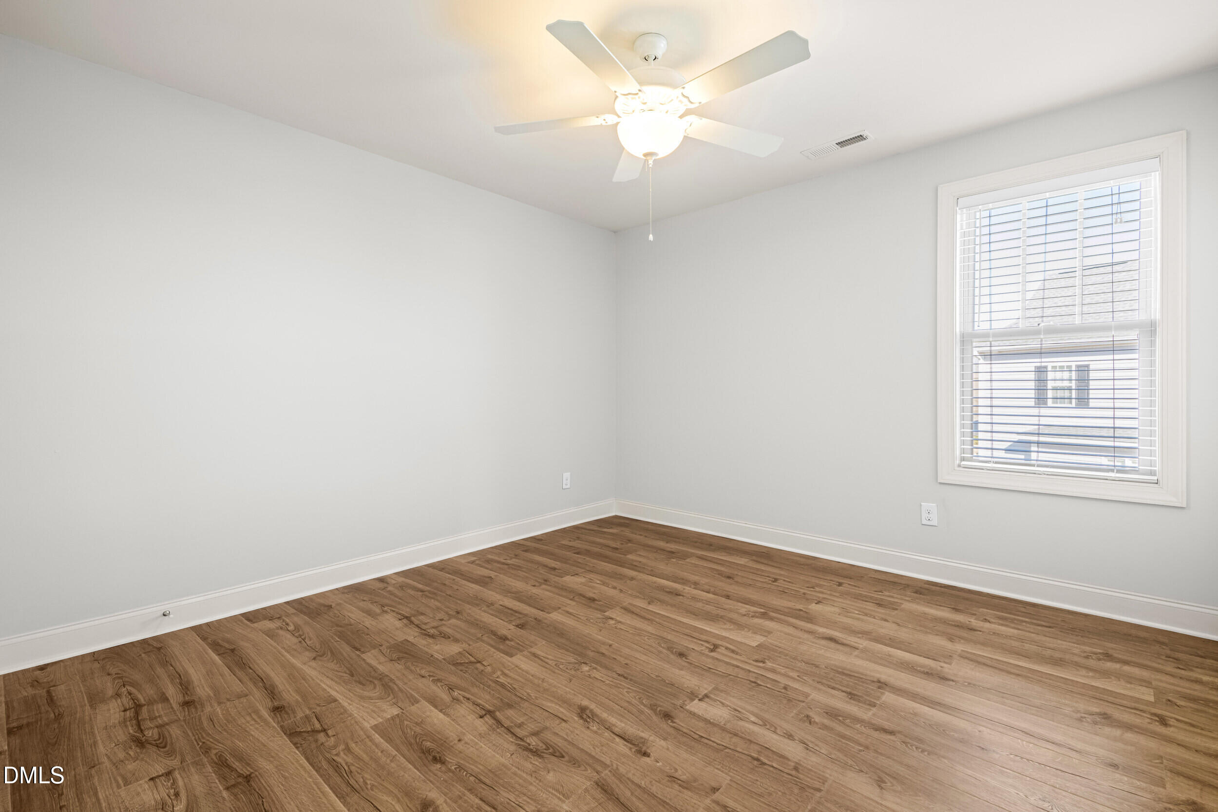 86 Sharpstone Lane Clayton, NC 27527 - Photo 27 of 36 wooden floor in an empty room with a window