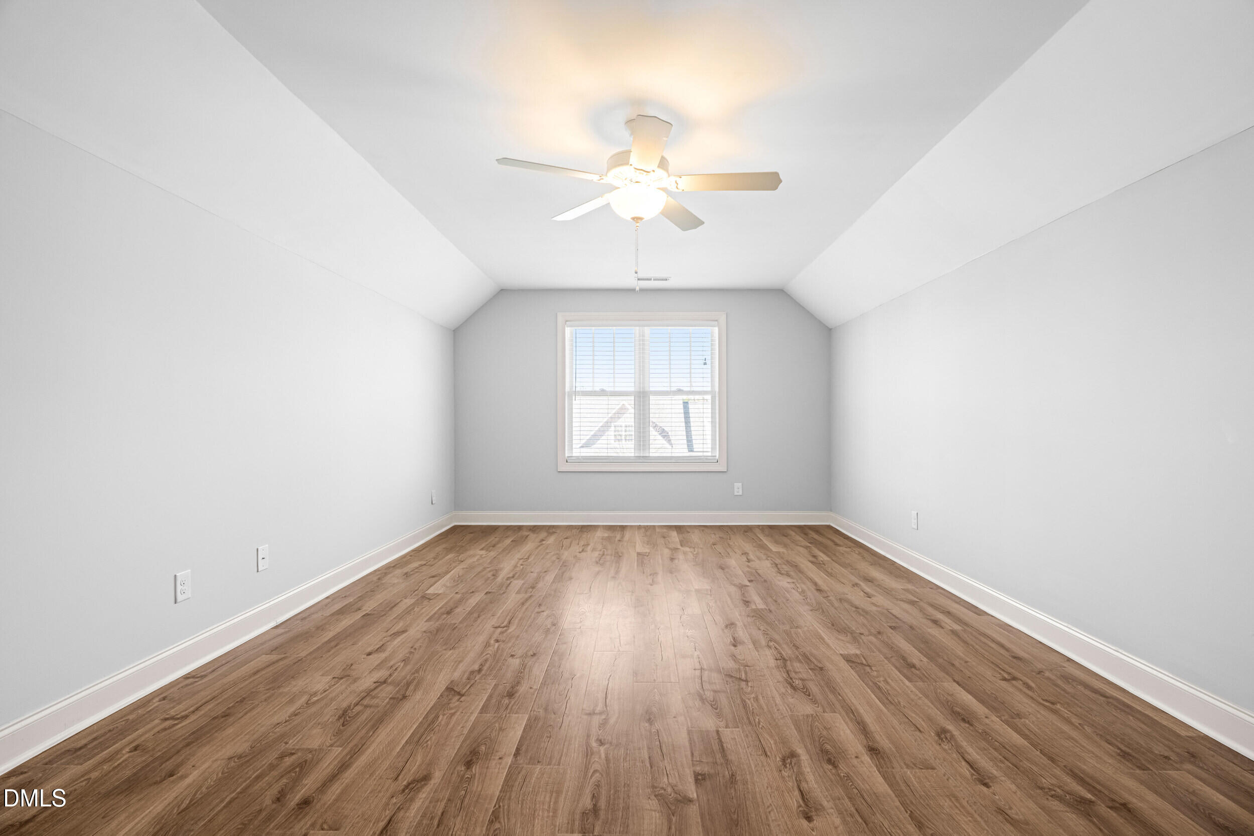 86 Sharpstone Lane Clayton, NC 27527 - Photo 28 of 36 an empty room with wooden floor chandelier fan and windows