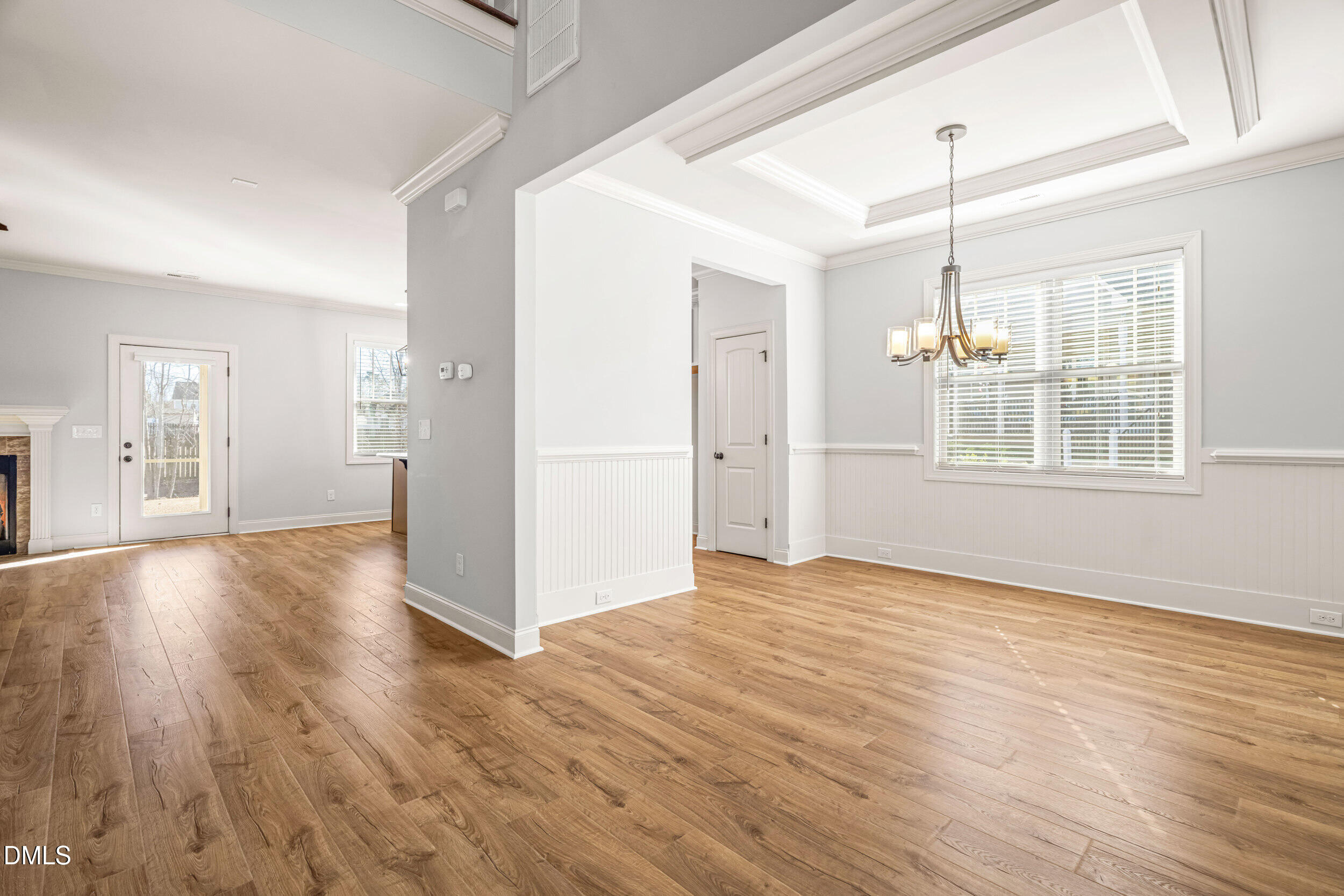 86 Sharpstone Lane Clayton, NC 27527 - Photo 4 of 36 a view of an empty room with wooden floor and a window