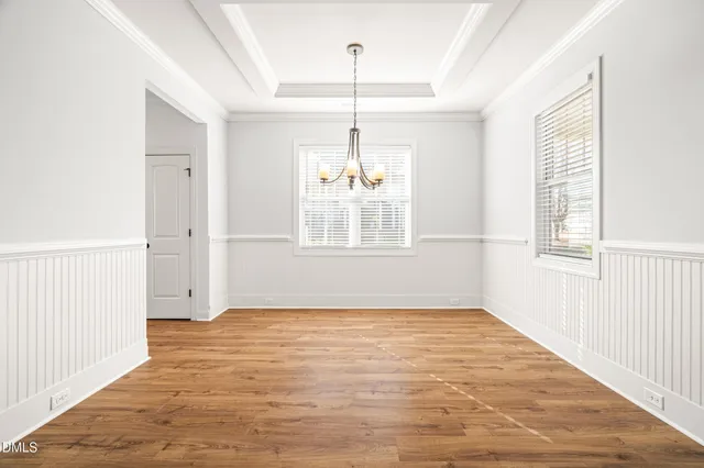 a view of empty room with wooden floor and stove