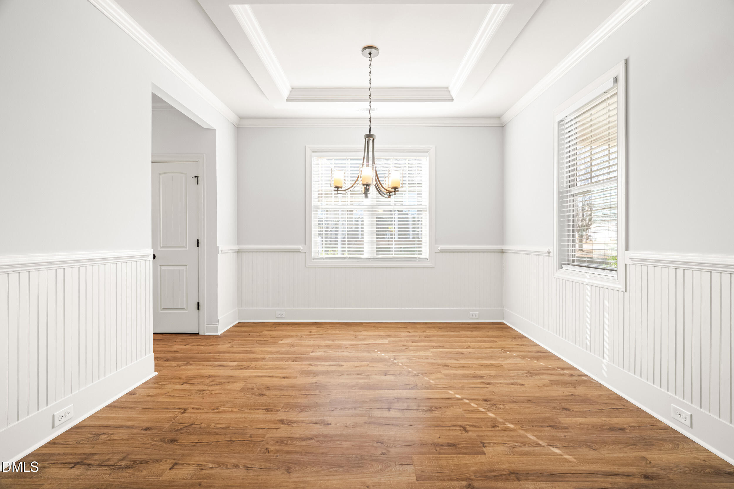 86 Sharpstone Lane Clayton, NC 27527 - Photo 5 of 36 an empty room with wooden floor cabinet and windows