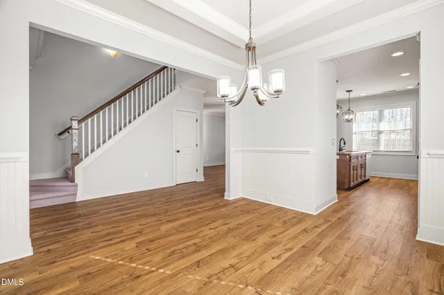 a view of kitchen with kitchen island stainless steel appliances wooden floor and window
