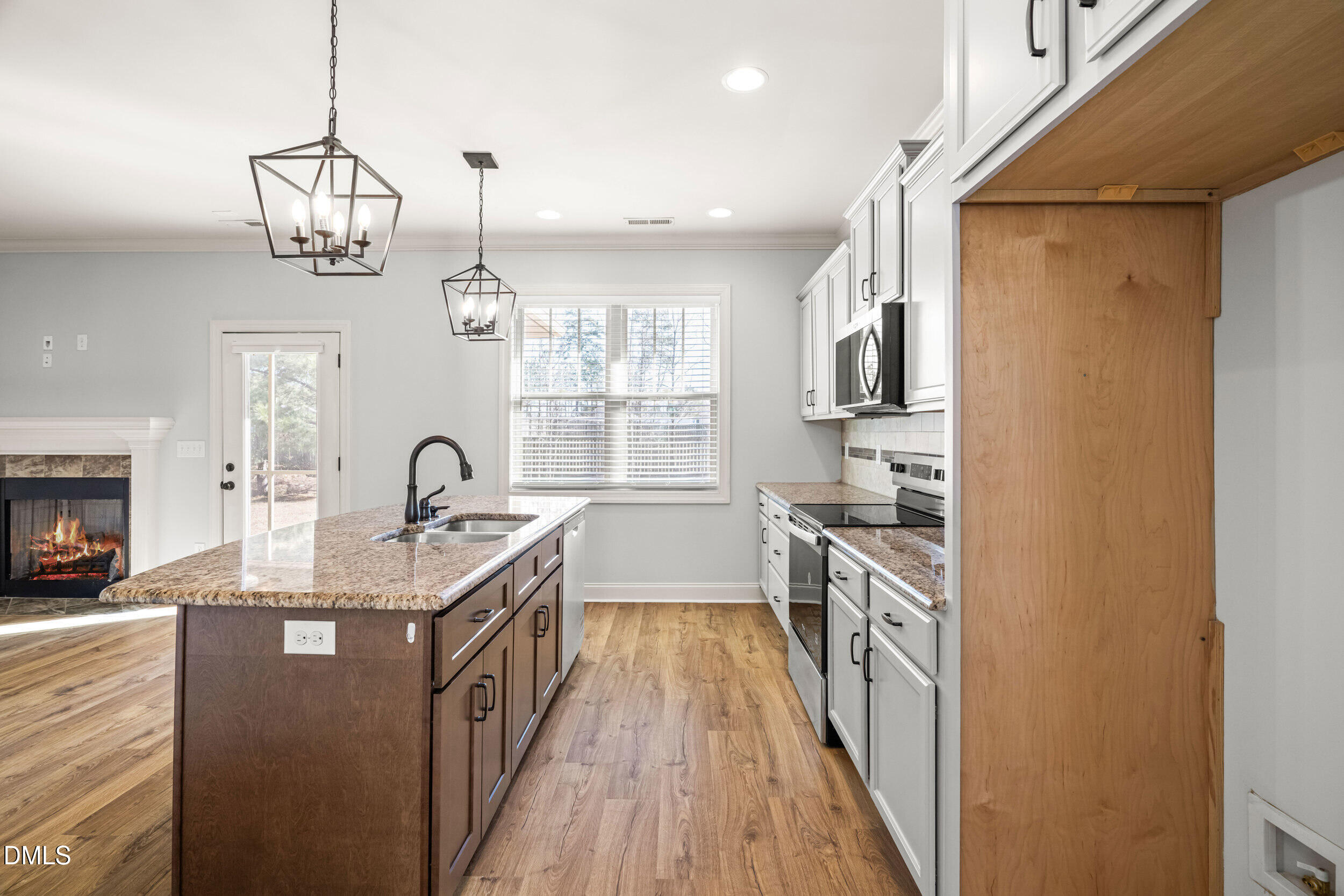 86 Sharpstone Lane Clayton, NC 27527 - Photo 8 of 36 a kitchen with kitchen island granite countertop lots of counter top space and stainless steel appliances