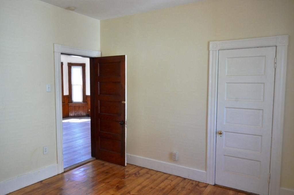71 Esther Street, Unit 2 Worcester, MA 01607 - Photo 13 of 19 an empty room with wooden floor & closet area