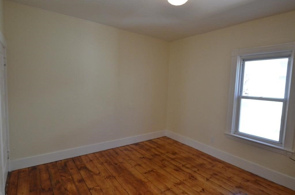 71 Esther Street, Unit 2 Worcester, MA 01607 - Photo 16 of 19 wooden floor in an empty room with a window