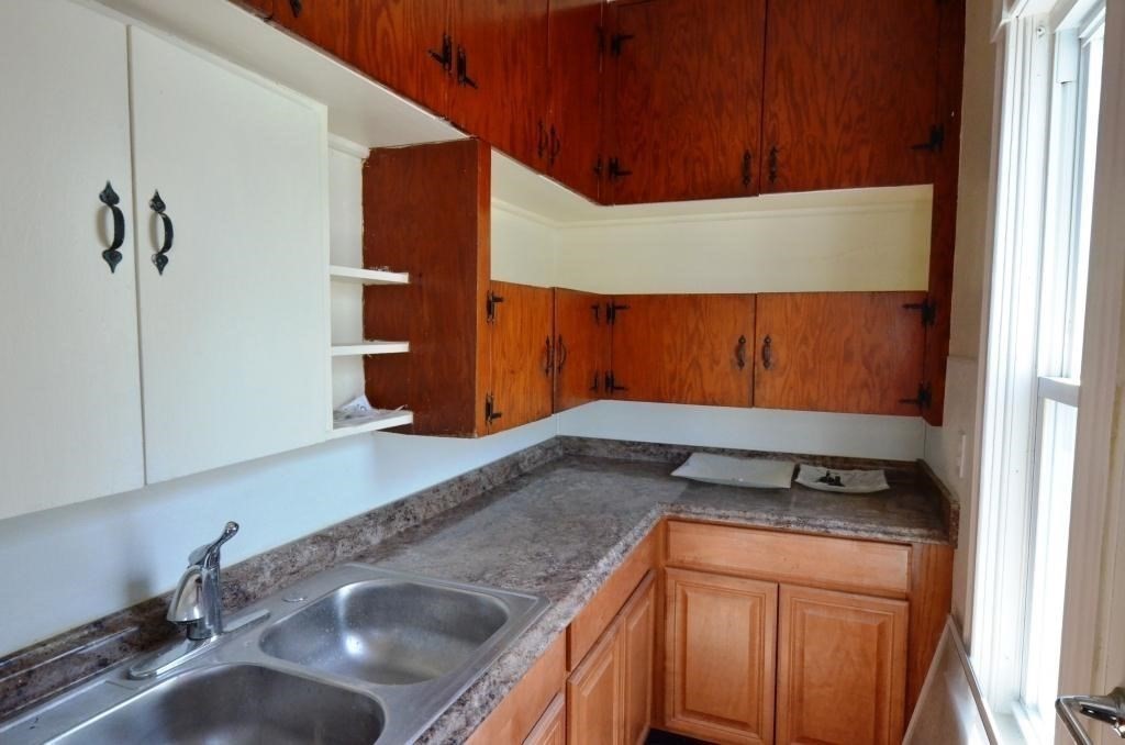 71 Esther Street, Unit 2 Worcester, MA 01607 - Photo 5 of 19 a kitchen with a sink and a refrigerator