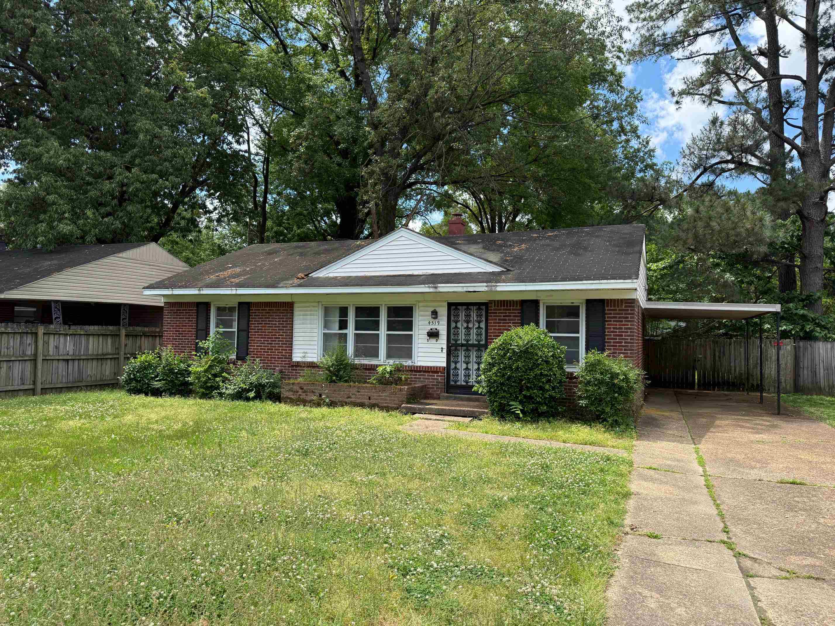 4519 Quince Road Memphis, TN 38117 - Photo 1 of 7 Ranch-style house with brick siding, driveway, and an attached carport