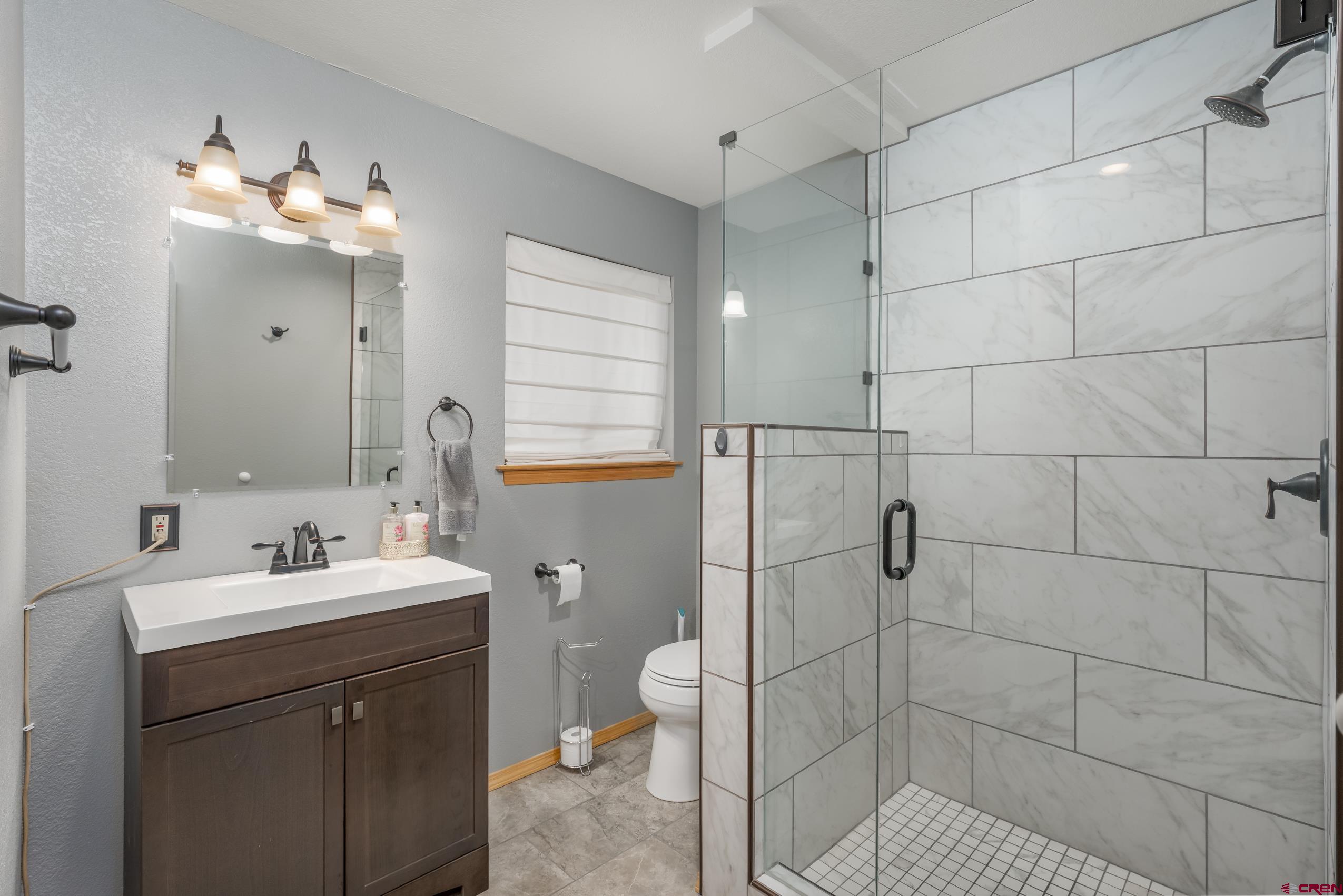 197 Buckhorn Road Bayfield, CO 81122 - Photo 15 of 34 a bathroom with a sink a toilet and shower