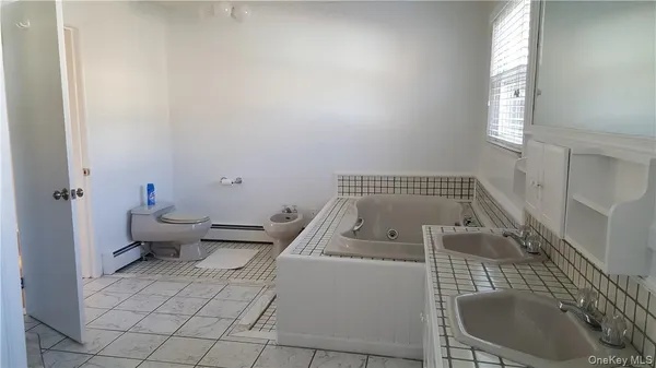 a kitchen with a stove a sink and a microwave