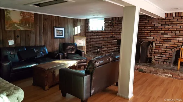 a view of a hallway with wooden floor and stairs