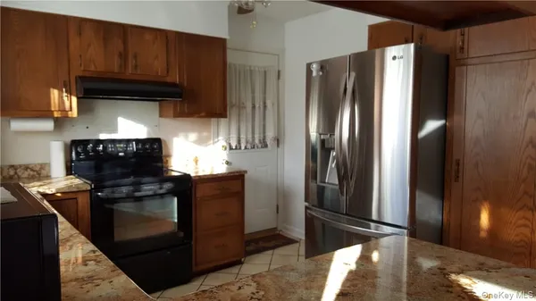 a kitchen with a table chairs and a chandelier
