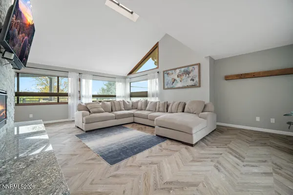 a kitchen with granite countertop white cabinets and stainless steel appliances