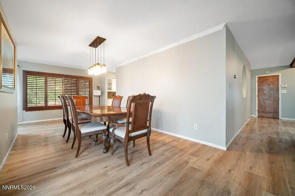 a dining room with furniture and wooden floor