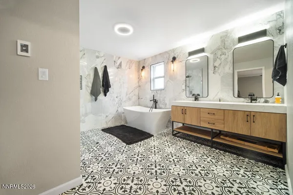 a bedroom with a bed couch and a window