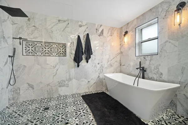 a bedroom with a bed workspace and window