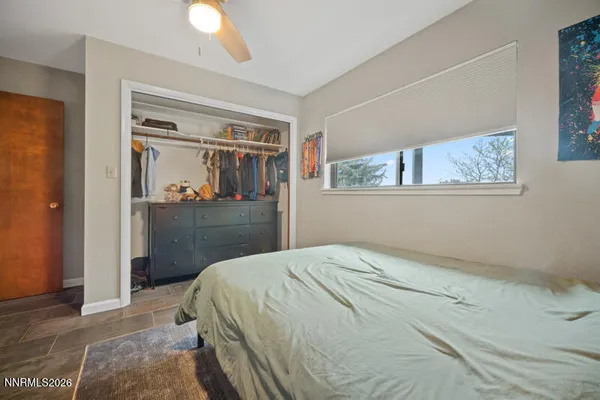 a living room with furniture a rug and a large window