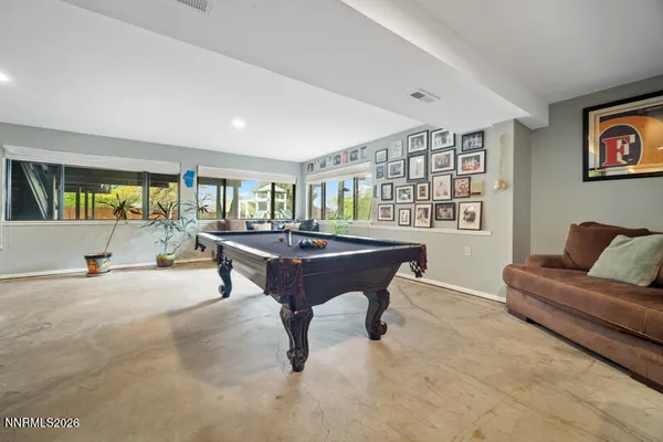 a bathroom with a sink a toilet a mirror and shower