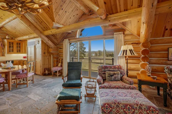 a living room with furniture and a ceiling fan