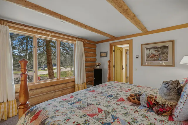 a bedroom with a large bed and a large window