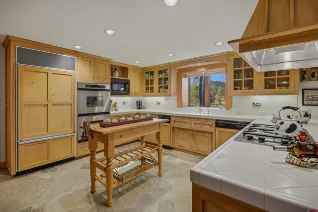 a kitchen with a sink appliances and cabinets