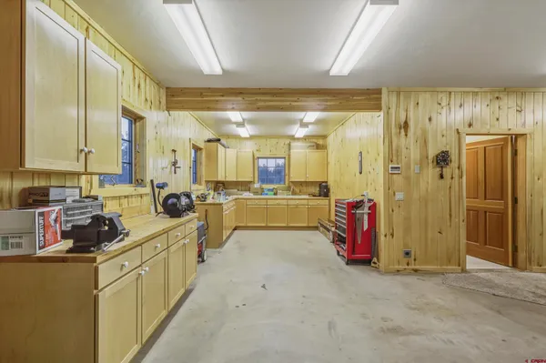 a view of a porch with wooden floor and furniture