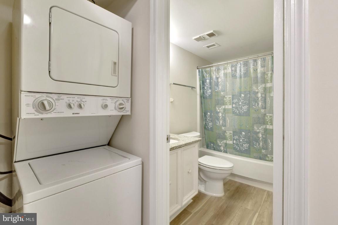 5837 Cove Landing Road, Unit 203 Burke, VA 22015 - Photo 20 of 25 Stacked washer and dryer in unit