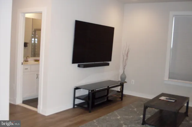 a kitchen with granite countertop a stove and a wooden floor