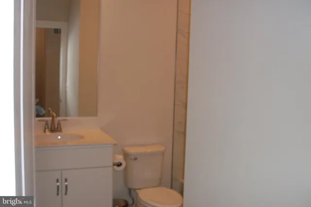 a large kitchen with stainless steel appliances a large counter top a stove and a refrigerator