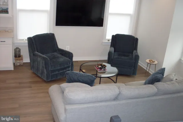 a kitchen with kitchen island white cabinets and stainless steel appliances