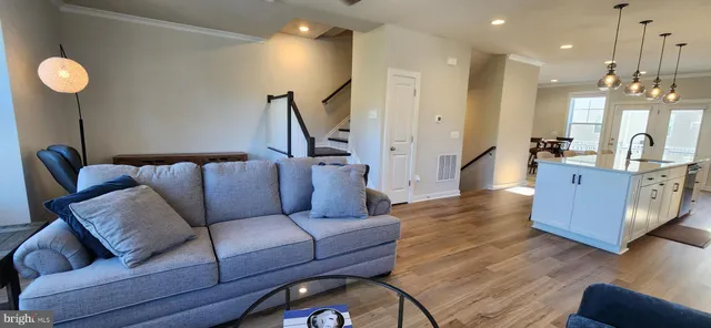 a kitchen with stainless steel appliances white cabinets and a refrigerator