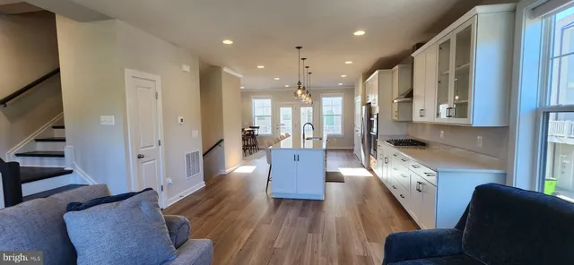a kitchen with stainless steel appliances granite countertop a sink and a refrigerator