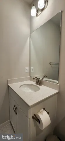 a view of a big yard with plants and large trees