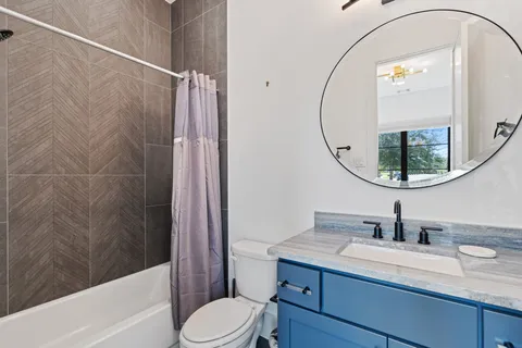 a living room with furniture a mirror a lamp and a dresser