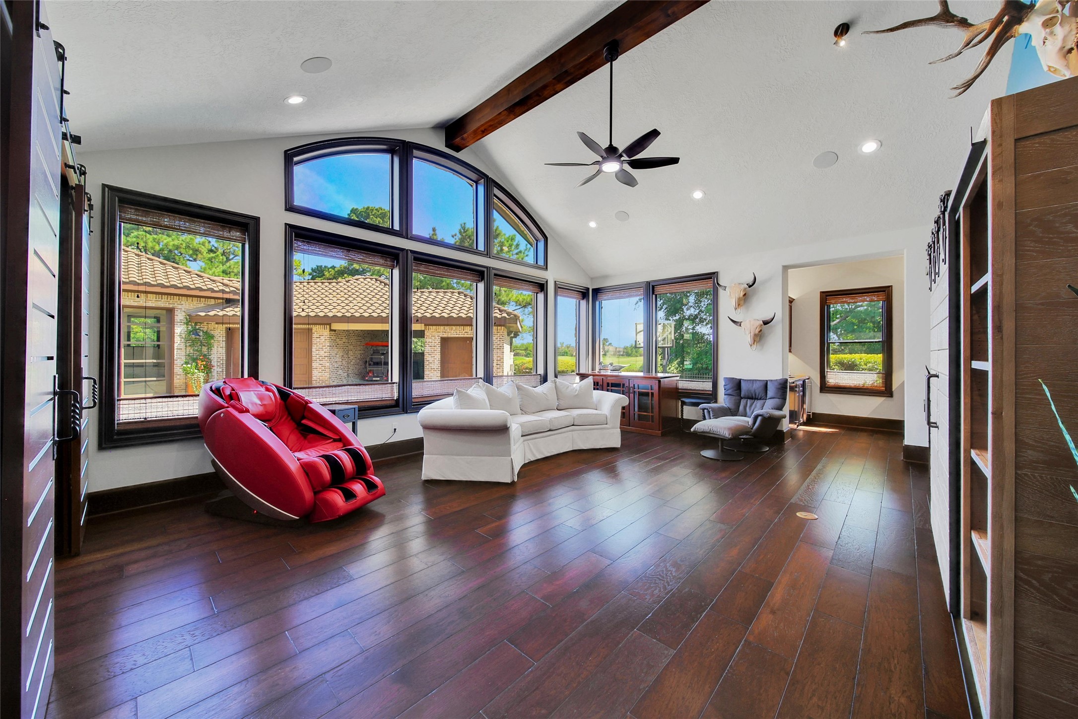 2 Highclere Park Drive Spring, TX 77379 - Photo 13 of 50 Situated just beyond kitchen, the private den offers a warm and inviting first-floor entertaining space featuring a full wet bar equipped with an ice maker, mini fridge, and ample cabinetry for storage. This versatile room is ideal for a billiards table or your favorite game-night setup.