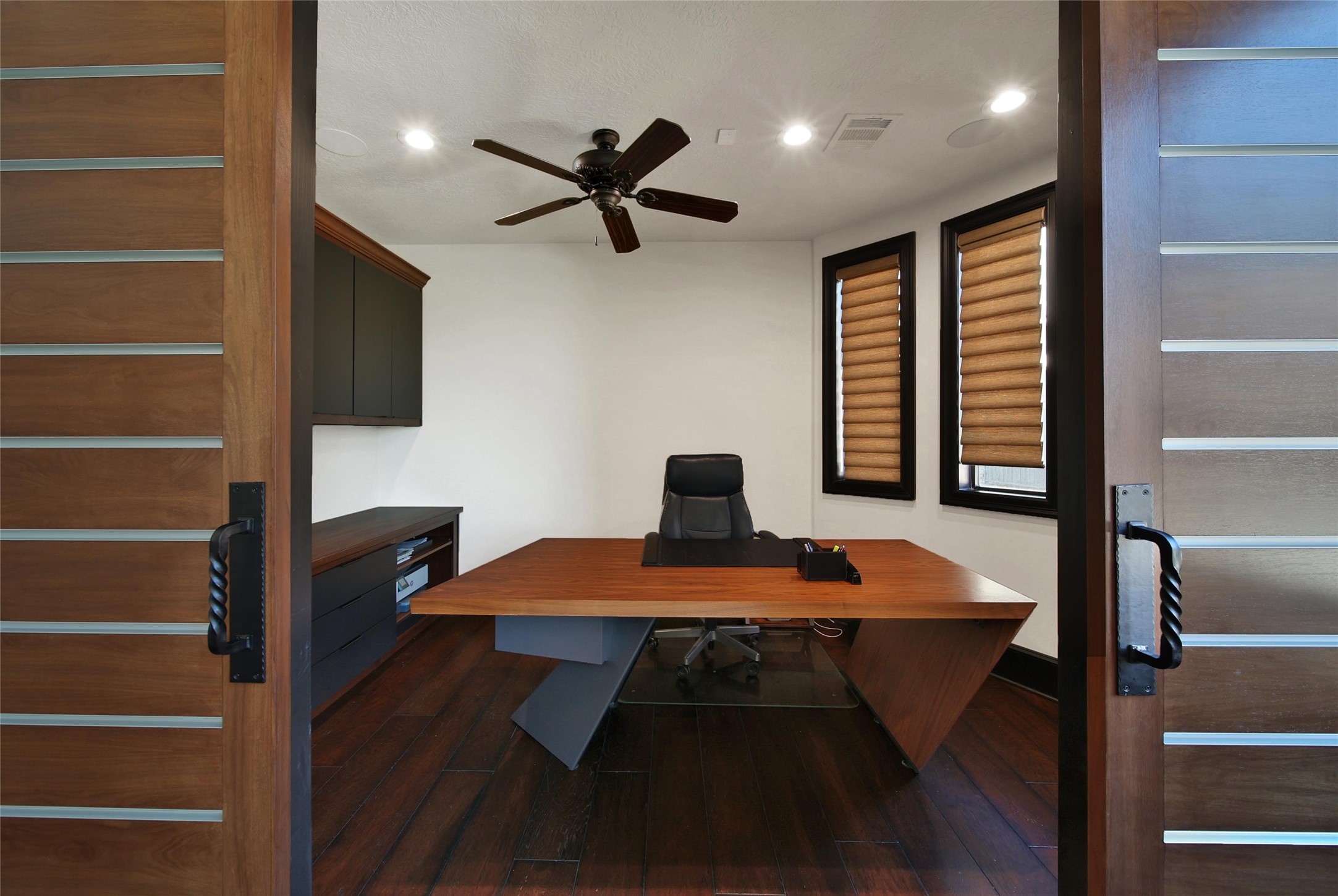 2 Highclere Park Drive Spring, TX 77379 - Photo 15 of 50 This modern private study features sleek built-in credenza and storage for a clean, organized look. Stylish modern barn doors add a contemporary touch.