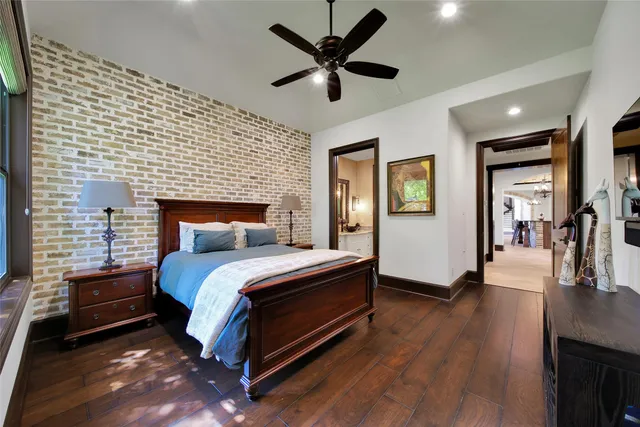 a bathroom with a granite countertop toilet a sink and a mirror