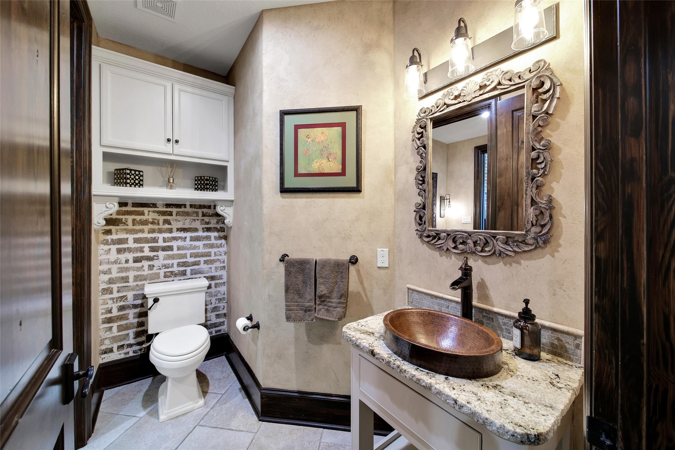 2 Highclere Park Drive Spring, TX 77379 - Photo 17 of 50 This is the powder room side of the shared en-suite connected to the first-floor guest bedroom. The adjoining section, accessible from the secondary bedroom, features a private sink and a walk-in shower. An additional half bath is conveniently located off the main family room.