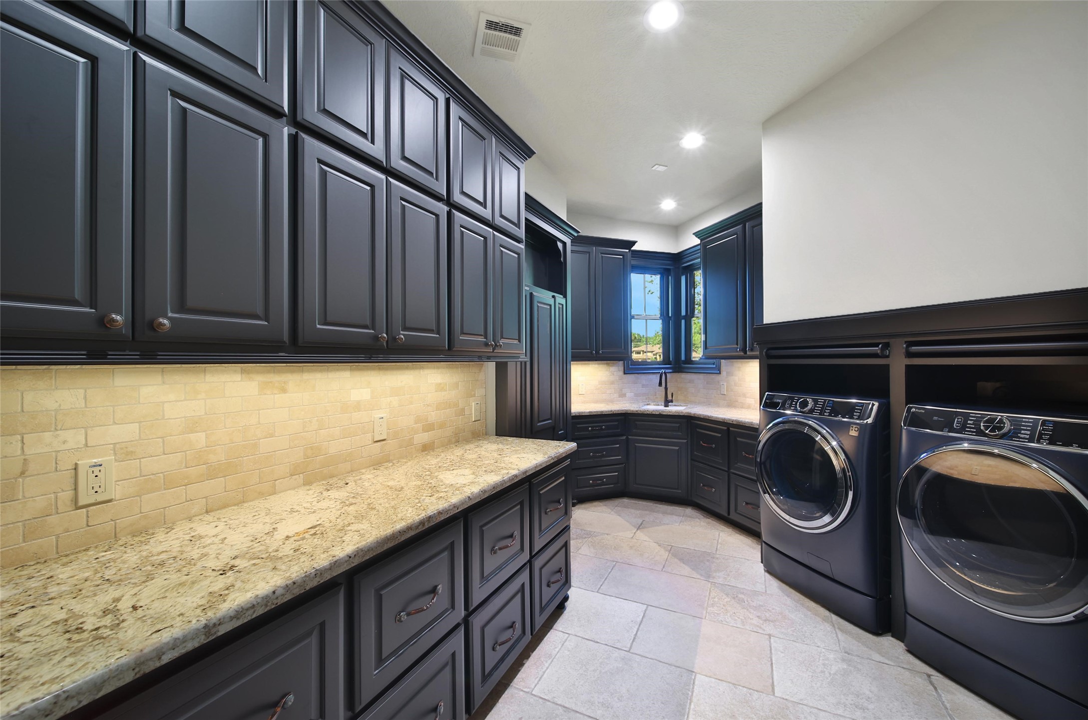 2 Highclere Park Drive Spring, TX 77379 - Photo 22 of 50 The first floor laundry room offers incredible storage and counters for folding. It's accessible from the hall just outside the primary suite or from inside one of the 2 walk-in closets.