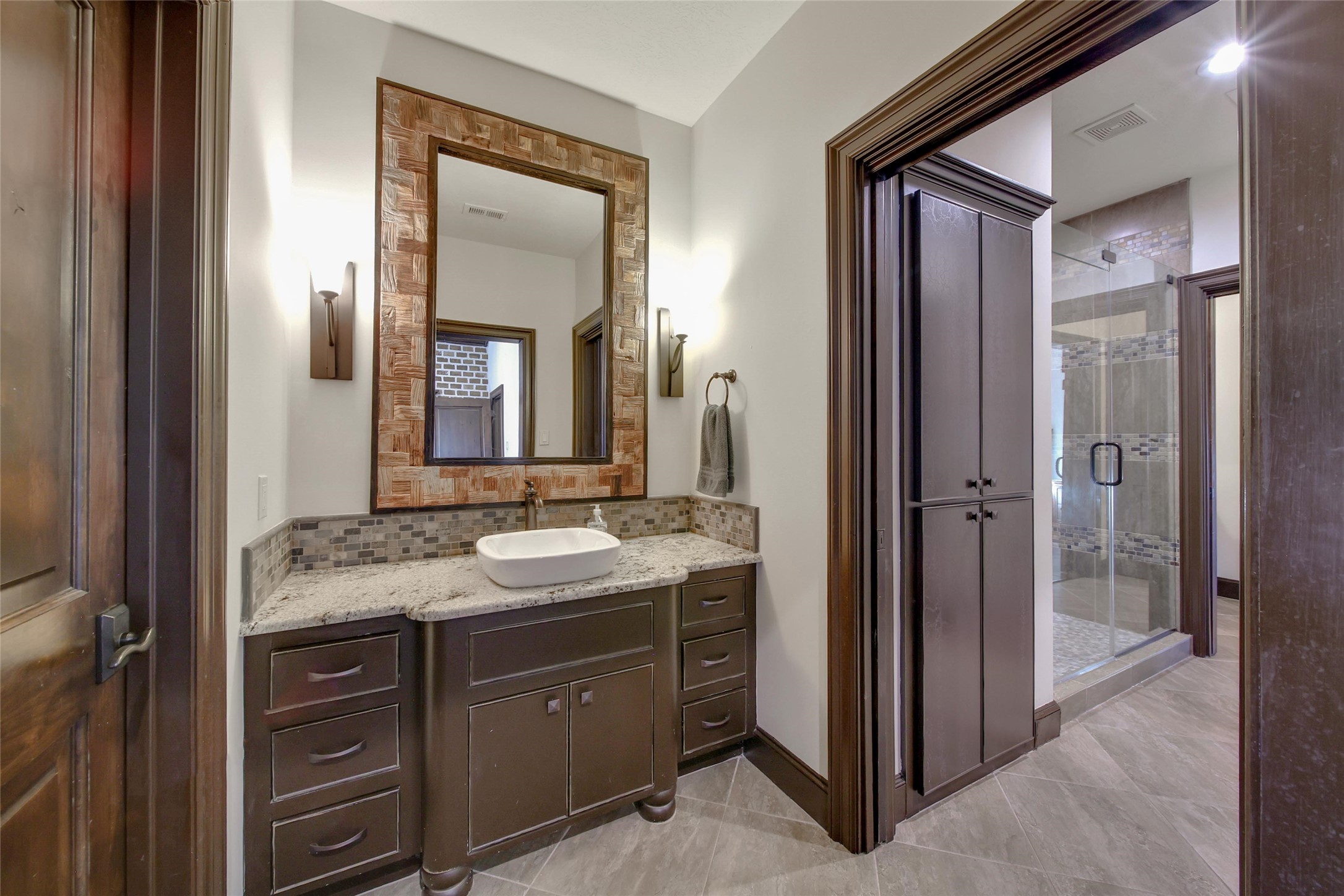 2 Highclere Park Drive Spring, TX 77379 - Photo 29 of 50 This shared bathroom is thoughtfully designed with a private sink area connected to each bedroom, a shower in the middle, and the toilet in the section that can be closed off and accessed from the hallway. Mornings just got easier.
