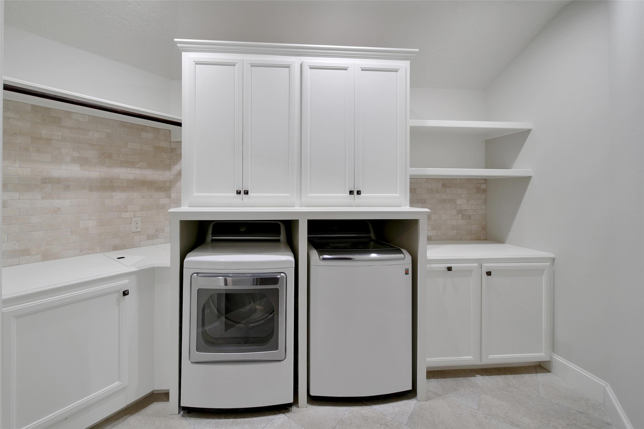 2 Highclere Park Drive Spring, TX 77379 - Photo 33 of 50 The upstairs laundry room is spacious and functional with cabinet and shelving space for storage, counters for folding, and a hanging bar for drying.