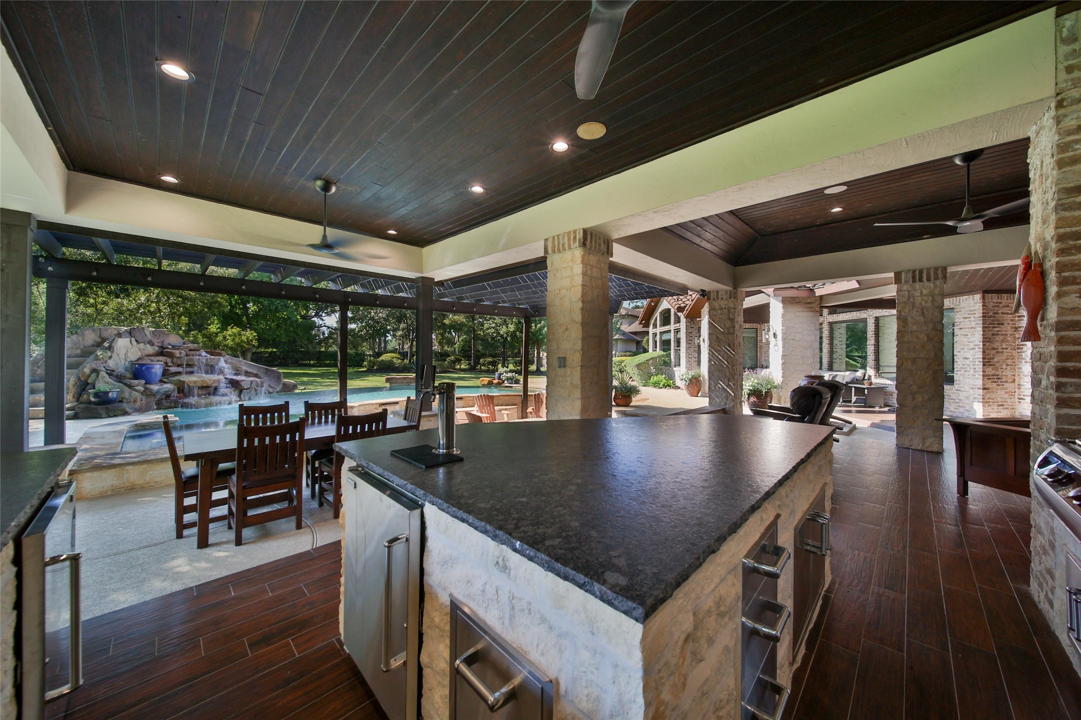 2 Highclere Park Drive Spring, TX 77379 - Photo 38 of 50 The chef enjoys prime views from the outdoor kitchen, just steps from a spacious dining area and versatile covered living space with flexible seating options.